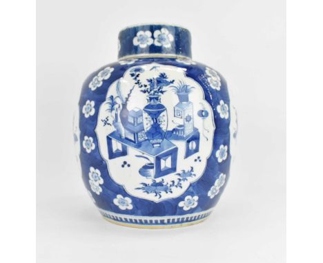 A large 19th century blue and white lidded ginger jar of baluster form, with panels of interior scenes within a blue ground w