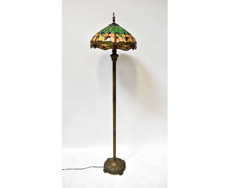 A brass column standard lamp with acanthus leaf and reeded decoration to circular base, with Tiffany-style shade, height incl