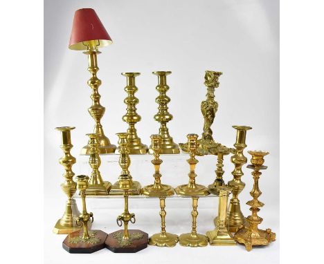 Various brass candlesticks, mainly 19th century, to include a Baroque-style stick with C-scrolls, and a French example with k