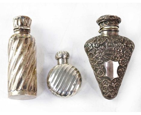 Three 19th century hallmarked silver scent bottles, comprising a heart-shaped example with embossed floral pattern and blank 