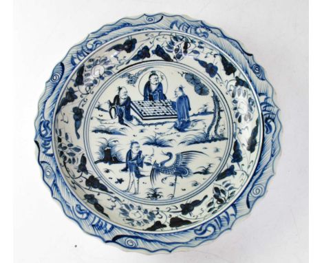 A large late 20th century Chinese blue and white shallow dish with shaped rim and central panel decorated with figures playin