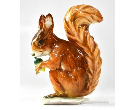 HUTSCHENREUTHER; a 20th century porcelain model of a red squirrel holding an acorn, printed mark, height 16cm.Condition Repor