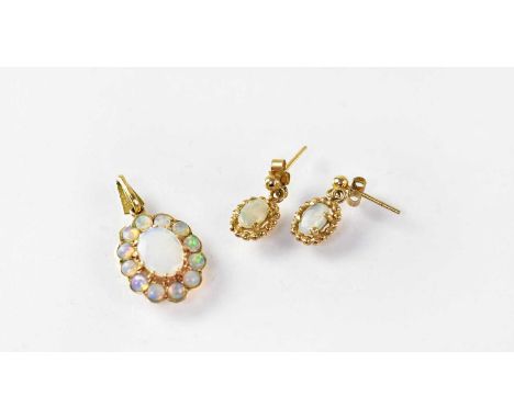 An opal cluster pendant in a 9ct gold mount, length 2.5cm, together with a matching pair of opal stud earrings, combined appr