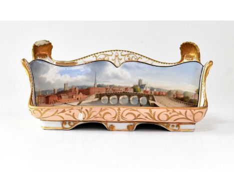 WORCESTER CHAMBERLAIN; a porcelain ink stand of cream and pink ground, painted with a Continental scene of a bridge over a ri