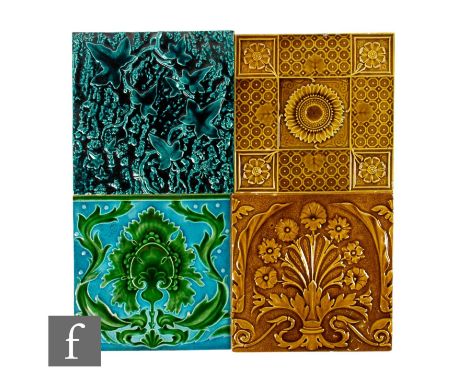 A collection of four later 19th Century to early 20th Century 8 inch dust pressed tiles, all with relief decoration, to inclu