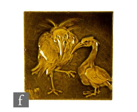 A late 19th Century Burmantofts Faience 6 inch dust pressed tile, circa 1890, heavily relief moulded with two grotesque birds