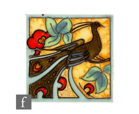 A 1930s Henry Richards 4 inch dust pressed tile, tube line decorated with a stylised peacock to a flowering bough, picked out