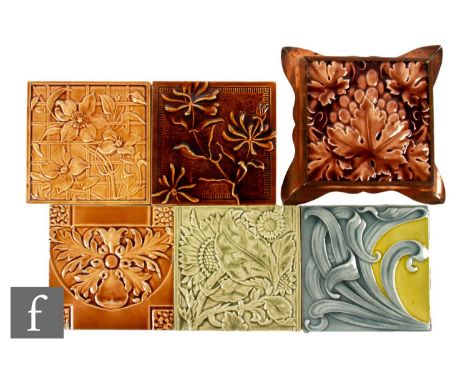 A Craven Dunnill &amp; Co 6 inch dust pressed tile, relief moulded with fruiting vines all in a brown glaze, mounted to a cop