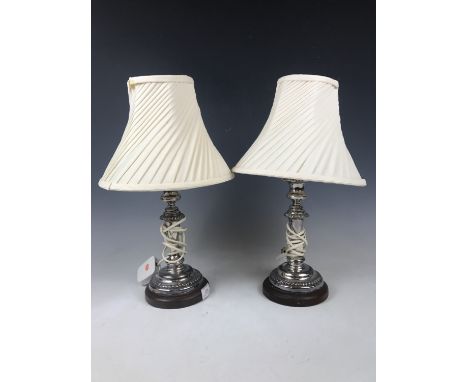 A pair of electroplate candlestick table lamps with shades