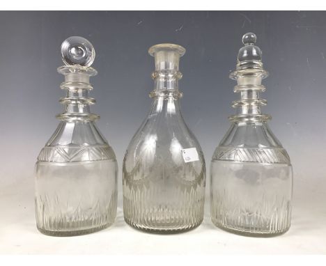 Two Georgian Prussian-bodied glass decanters (one a/f) together with a Georgian club decanter, (with associated stoppers)