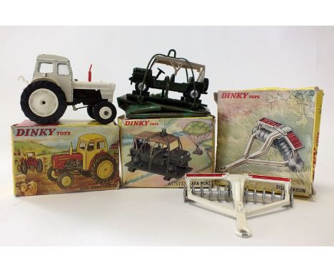 A group of three boxed Dinky Toys, to include a No 305 David Brown Tractor in white, a No 322 Disc Harrow and a No 601 Austin