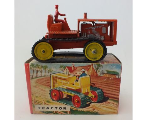 A boxed Benbros Quality Tractor, the model in orange with original black tracks and driver, overall length 10cms
