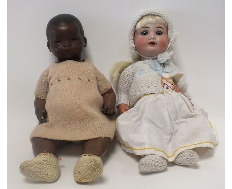 Two mid-twentieth century dolls, to include a black doll by Armand Marseille, with bisque head and sleeping brown eyes, the h