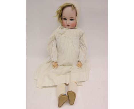 An early 20th Century Simon and Halbig for Kammer and Reinhardt and bisque head girl doll with blonde wig, striated blue glas