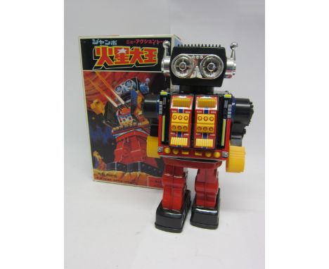 A boxed SH (Horikawa), Japan, battery operated plastic and tinplate robot with chest opening to reveal two guns, 30cm tall. 