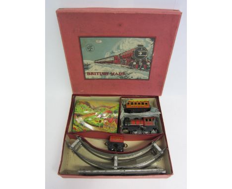 A Brimtoy 0 gauge train set no.500/4, comprising clockwork tinplate 0-40 locomotive, tender, first class coach, track and tun