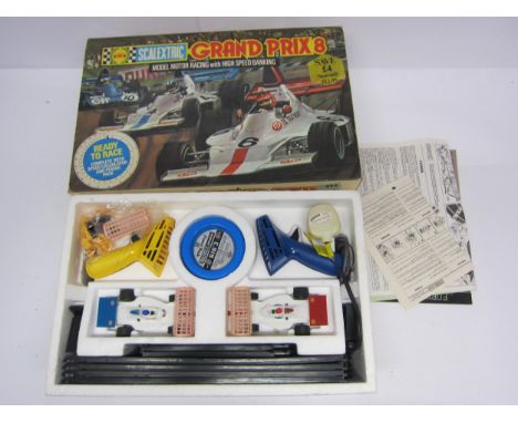 A boxed Scalextric Grand Prix 8 slot racing set and additional track 