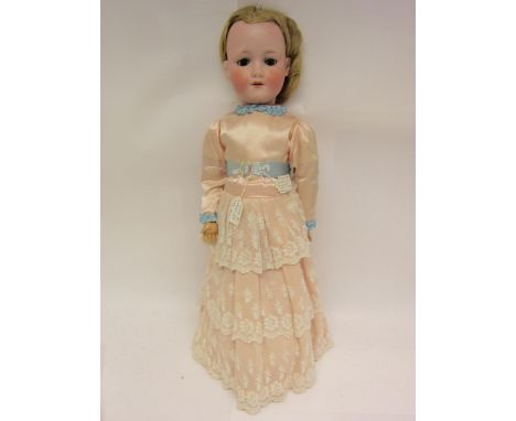 An early 20th Century Armand Marseille bisque head walking doll, with blonde wig, brown glass sleepy eyes, painted features, 