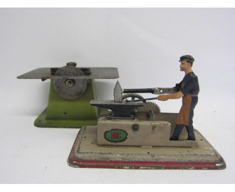 Two German steam driven accessories to include Doll et Cie cast metal blacksmith with hammer and anvil on tinplate base and M