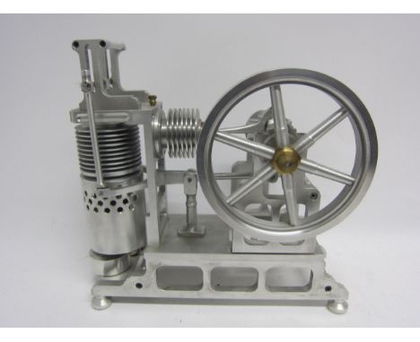A large polished cast metal model Stirling hot air stationary engine with vertical cylinder working a single crank motion wit