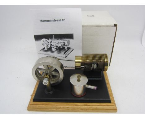 A PM Research Solar Engines flame eater hot air vacuum engine with chrome plated flywheel and brass machined cylinder raised 