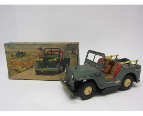 An Alps (Japan) battery operated tinplate Electric Jeep, with electric headlights, folding windscreen and metal shovels to si