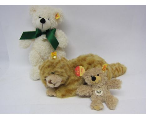 Three Steiff soft toys, all with buttons and yellow tags to ears, comprising ginger cat, Yorkshire Tyke teddy bear and teddy 