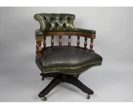 A Modern Green Leather Upholstered Swivel Office Chair with Button Back Rest and Turned Spindles 