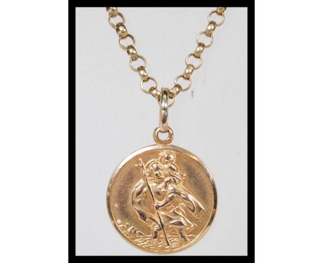 A hallmarked 9ct gold St Christopher pendant on a hallmarked 9ct gold figaro chain link necklace. Chain length 20", gross wei