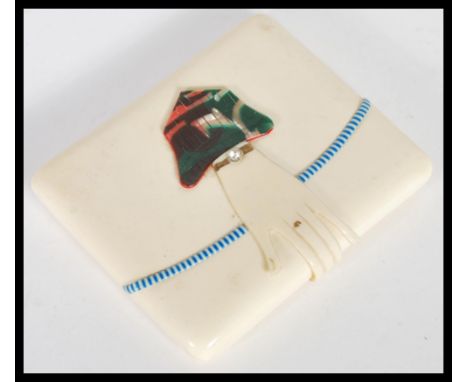 A vintage celluloid Art Deco 1920's cigarette case including a celluloid folded hand clasp with an inlaid white stone into th