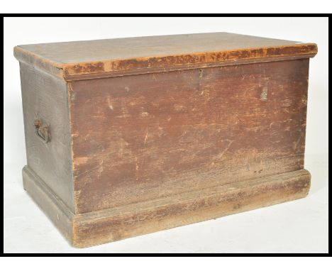 A 19th Century pine trunk coffer chest box having wrought iron drop handles and having painted top. The long rat tail hinged 