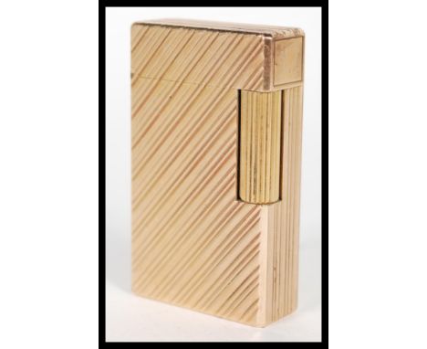 A vintage yellow metal Dupont of Paris gentleman's cigarette lighter having Chevron design with serial no and stamps for Dupo