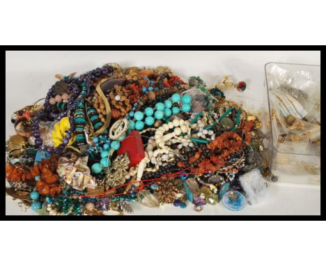 A collection of good vintage costume jewellery to include amber, coral, malachite, shell, pearl necklaces, brooches, earrings