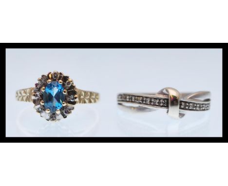 Two hallmarked 9ct gold ring to include a gold ring set with an oval cut blue stone and a halo of white stones and engraved d