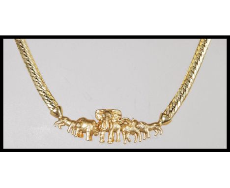 A 9ct gold necklace having a flat link chain with a attached to a pendant in the form of African animals with a lobster clasp