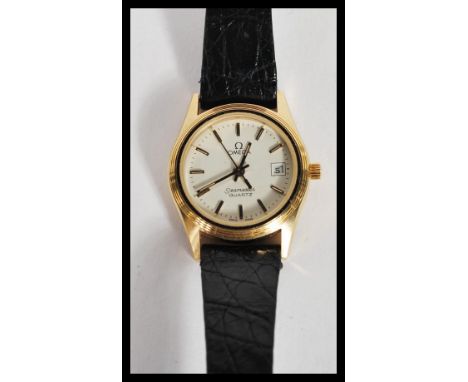 A vintage ladies Omega Seamaster Quartz watch set to a leather strap. The white enamel face having silver baton numerals and 
