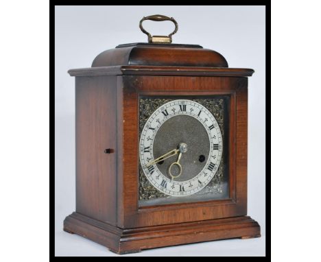 A vintage early to mid 20th Century Smiths Enfield walnut cased mantel bracket clock in the 17th Century style raised on plin