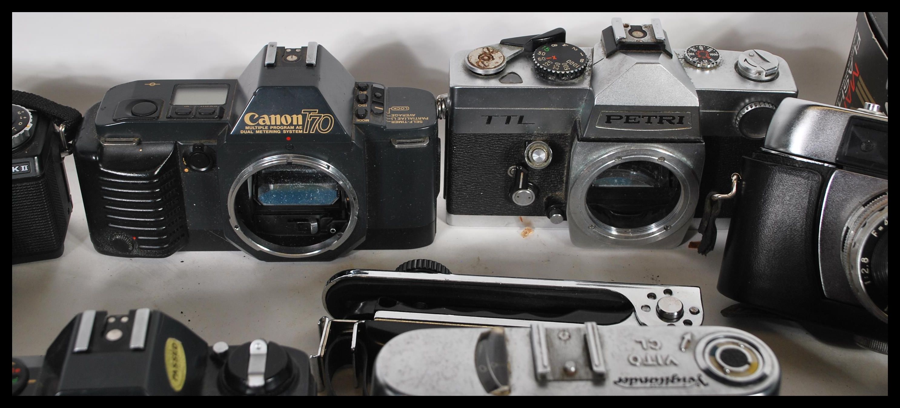 A collection of film photographic equipment to include film cameras and
