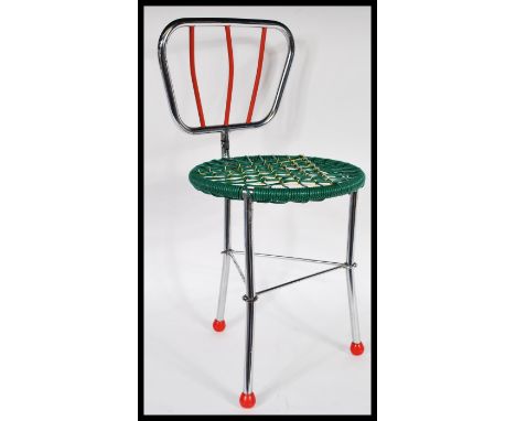 A vintage retro 20th Century folding metamorphic childs chair of tubular form raised on three chrome legs with atomic style f