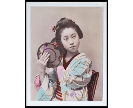 A late 19th Century Victorian hand - tinted albumen print photograph, the mounted studio photograph of a young girl in tradit