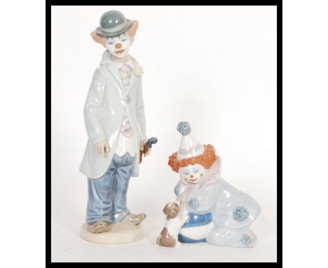Two vintage Lladro ceramic figurines depicting clowns to include a clown with violin 5472 and clown with dog 527B. Printed an