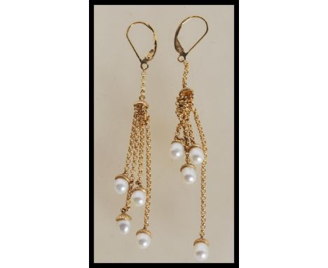 A pair of 9ct gold drop earrings consisting of graduating chains set with white pearls to the ends. Total weight 4.9g. 7cm lo