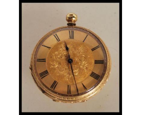 An early 20th Century continental fob open face pocket watch within a stamped 18k gold case, having a gold tone face with rom