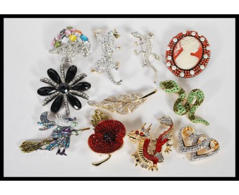 A collection of vintage crystal encrusted costume brooches by Adrian Buckley to include a Chinese Dragon, a snake, a witch fl