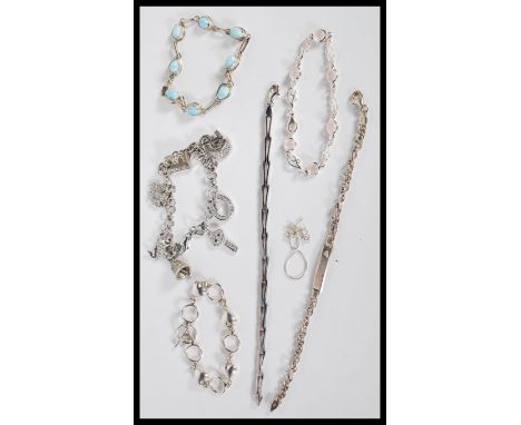 A selection of stamped 925 silver bracelets to include a spacer bracelet set with light blue stones, a bracelet with scrolled