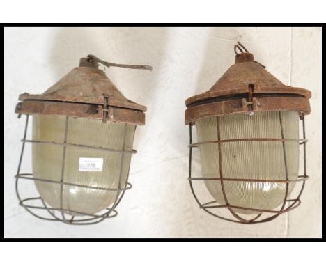 A pair of vintage / retro&nbsp; 20th Century industrial factory bulkhead cage lights, having a cast body, glass protection ov