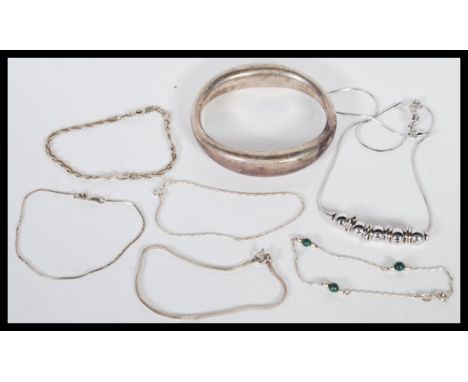 A collection of silver bracelets, to include a chunky bangle, silver necklace with ball and rings decoration and five bracele