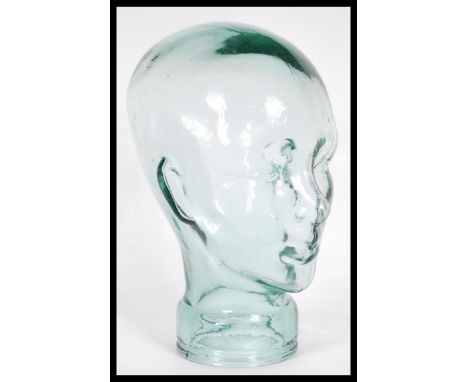 A vintage retro 20th century shop display / millinery mannequin head of pressed glass construction with moulded features. 29c