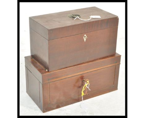 A 19th Century Georgian mahogany tea caddy having a swing handle to the top and ivory escutcheon to the front, having two com