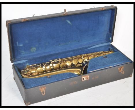 A 20th Century Elkhart saxophone with a gold lacquer finish having mother of pearl keys, set within a fitted carrying case ha
